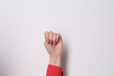 Photo of SOS gesture. Woman showing signal for help on white background, closeup