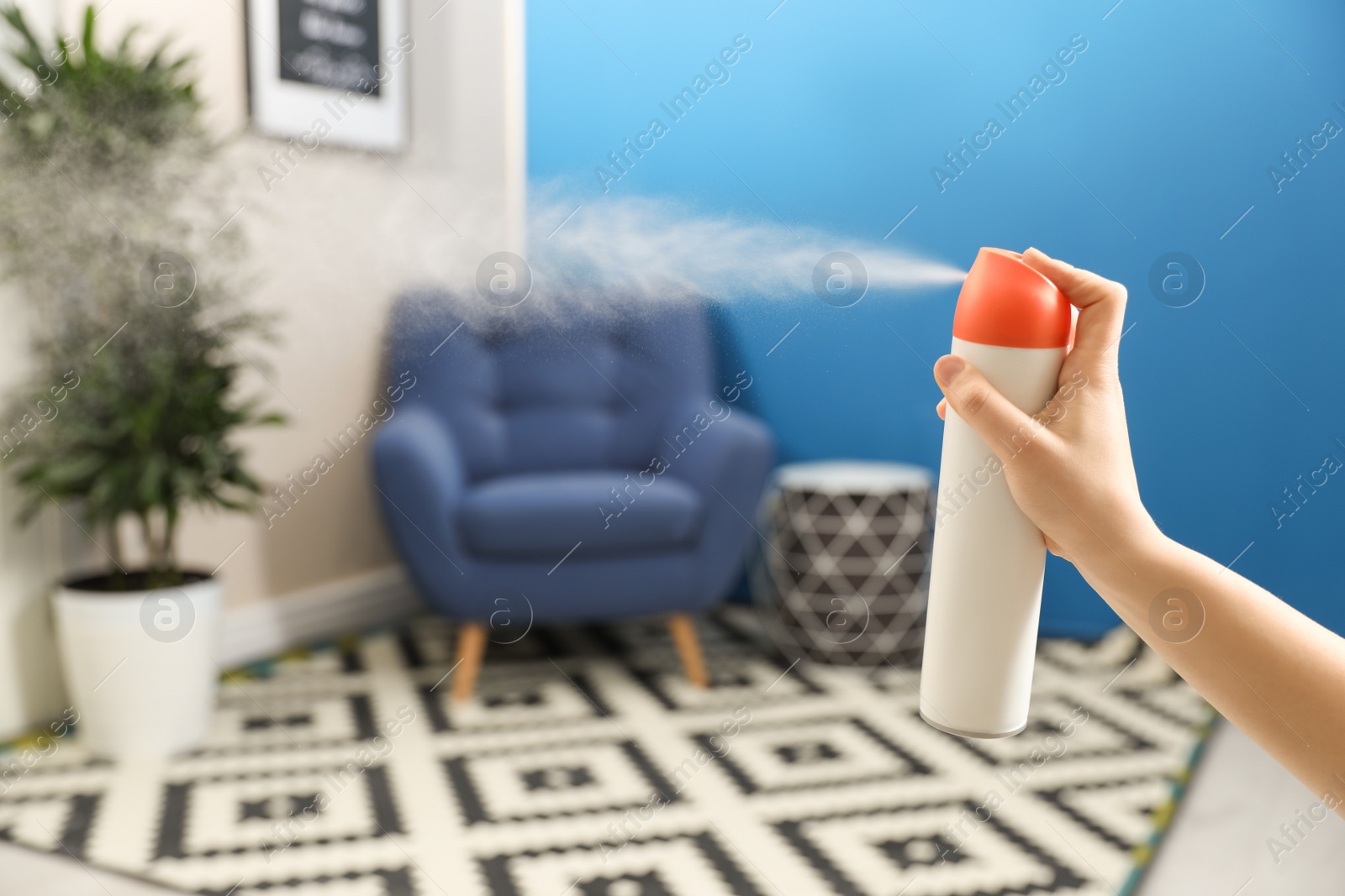 Photo of Woman spraying air freshener at home, closeup