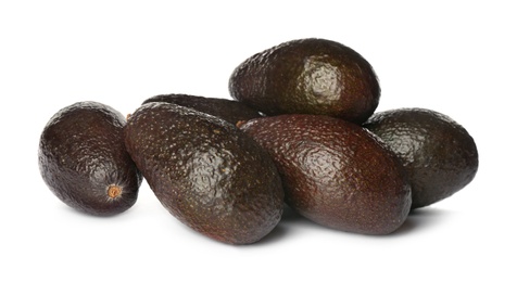 Whole fresh ripe avocadoes on white background