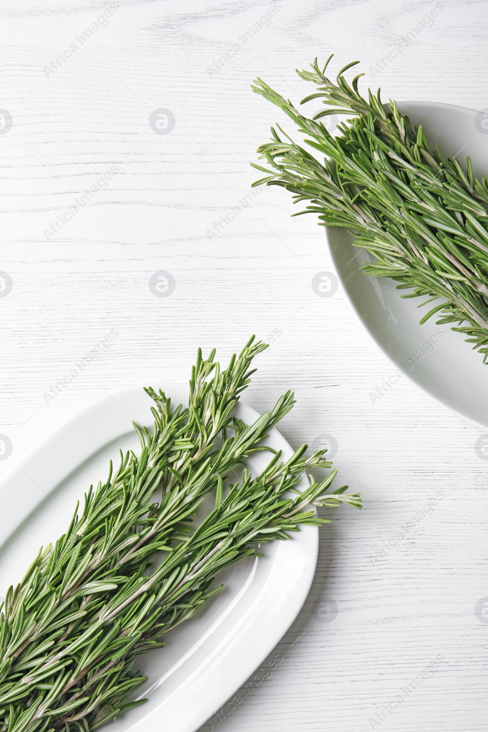 Photo of Flat lay composition with rosemary on wooden background. Aromatic herbs