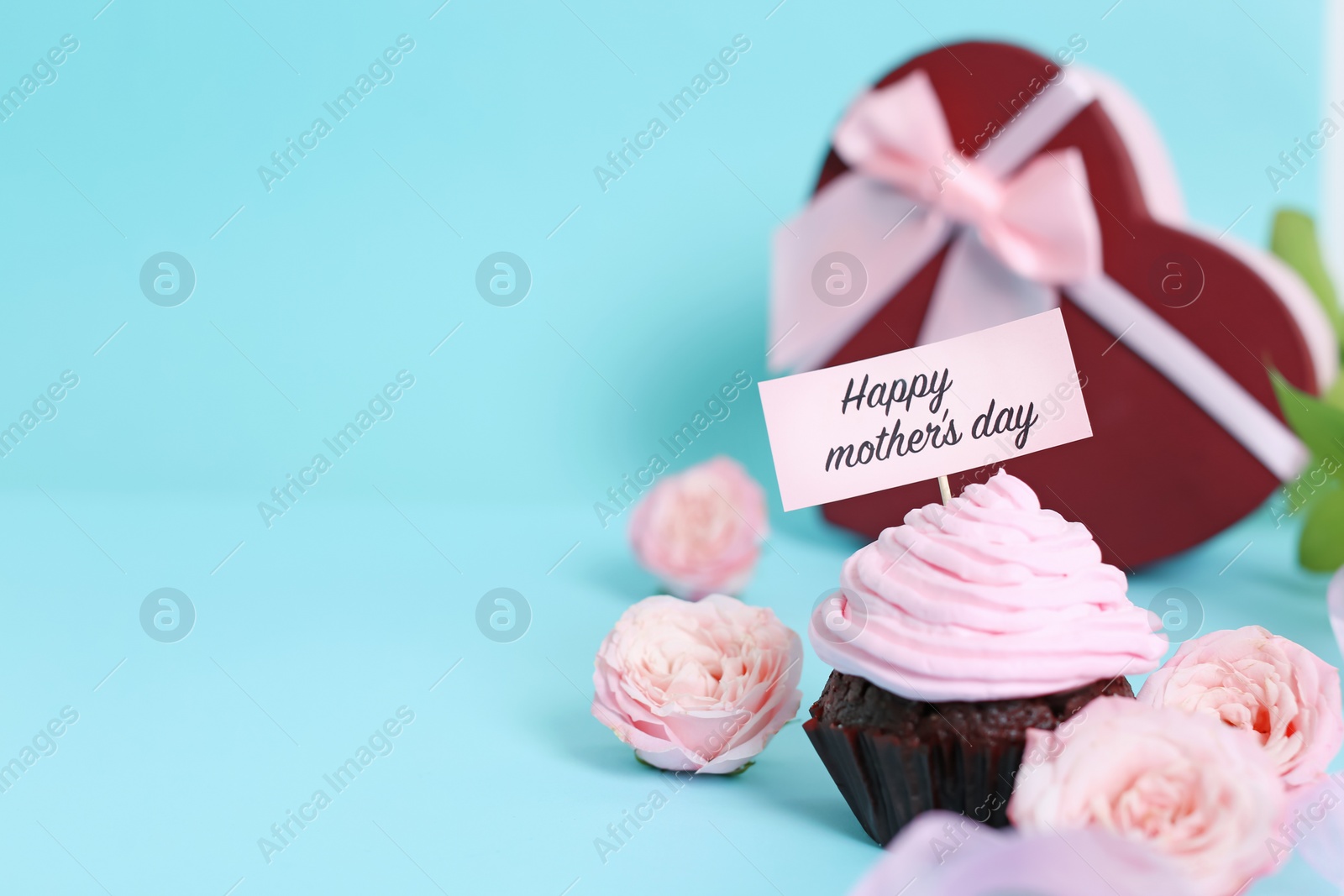 Photo of Festive surprise with tasty treat for Mother's Day on color background