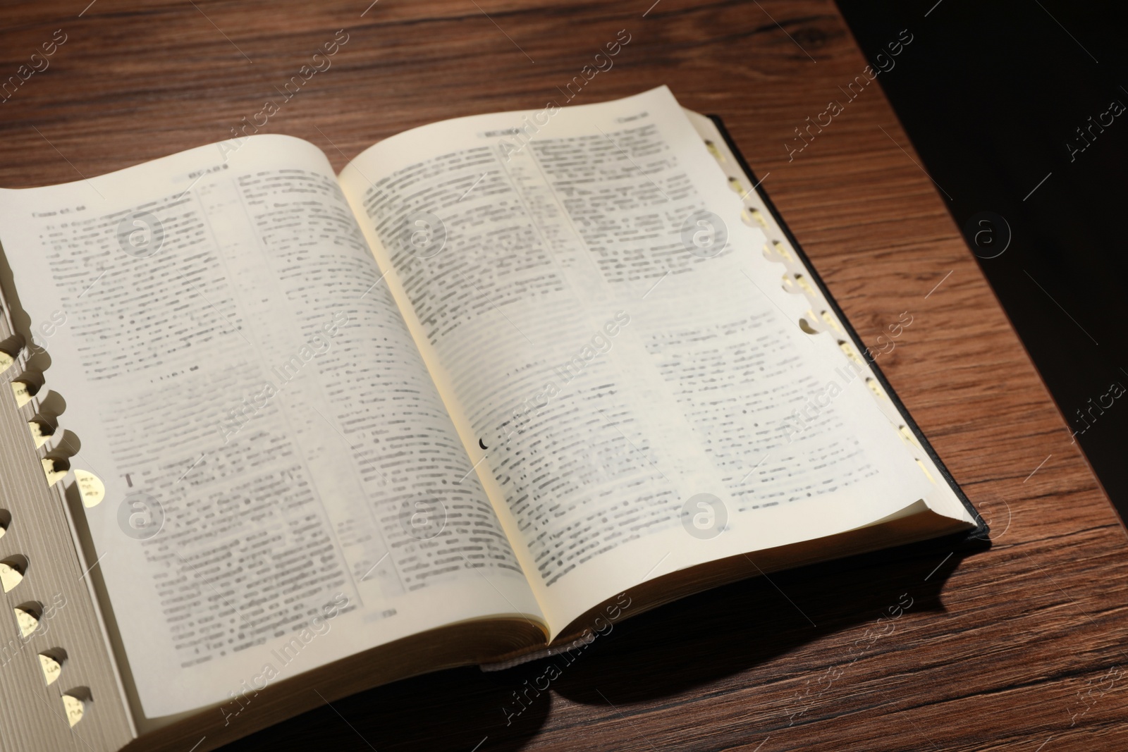 Photo of Open Bible on wooden table. Christian religious book