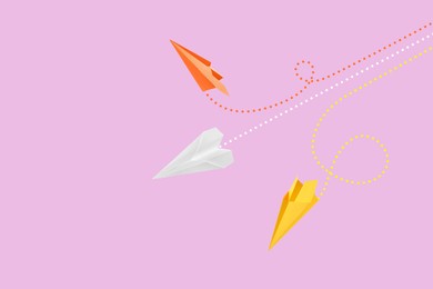 Image of Handmade paper planes on pink background. Space for text