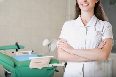 Young gynecologist at workplace in clinic, closeup. Space for text