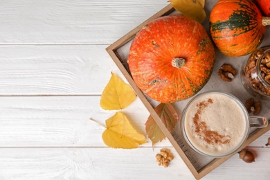 Photo of Flat lay composition with cup of pumpkin spice latte and space for text on table