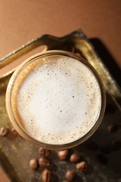 Photo of Aromatic coffee with milk in glass on table, top view