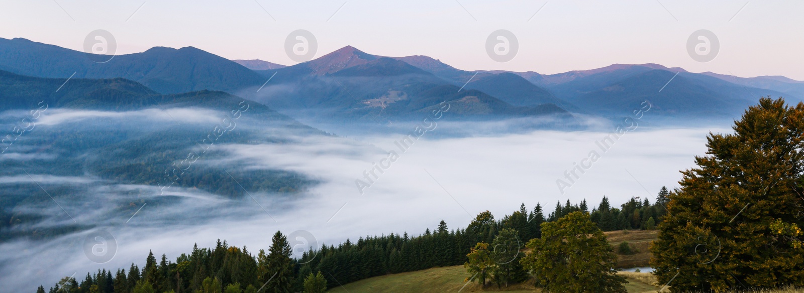 Image of Picturesque misty mountains under beautiful sky, banner design