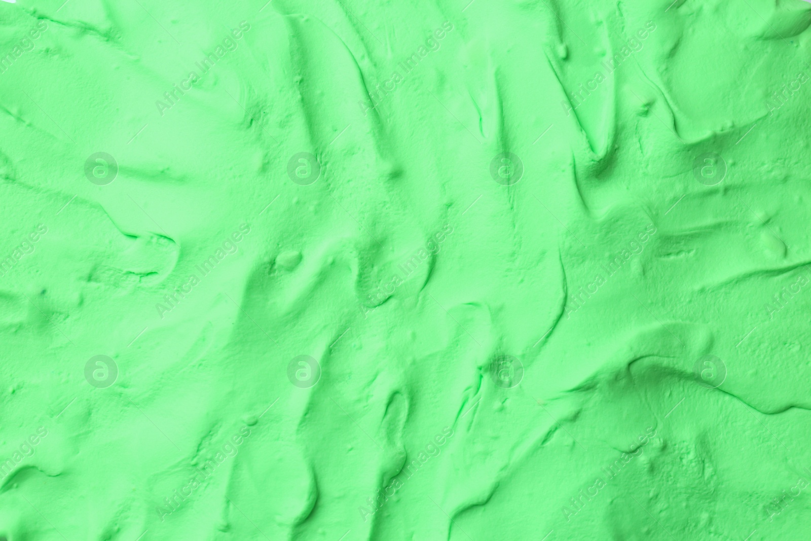 Photo of Light green play dough as background, top view