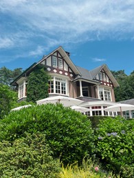 Picturesque view of beautiful house and plants on sunny day