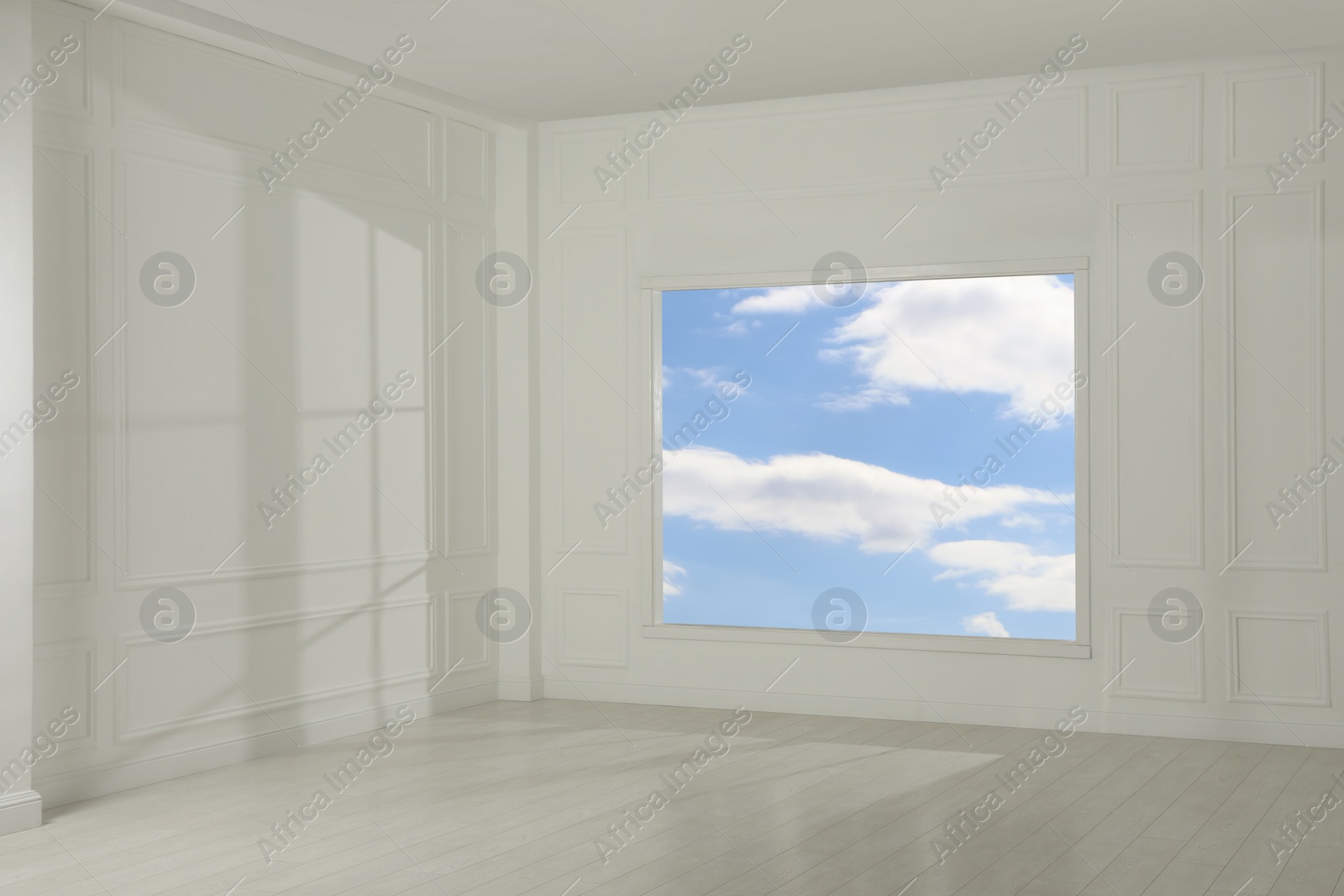 Photo of Empty room with white walls and large window