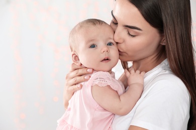 Portrait of happy mother with her baby against blurred lights