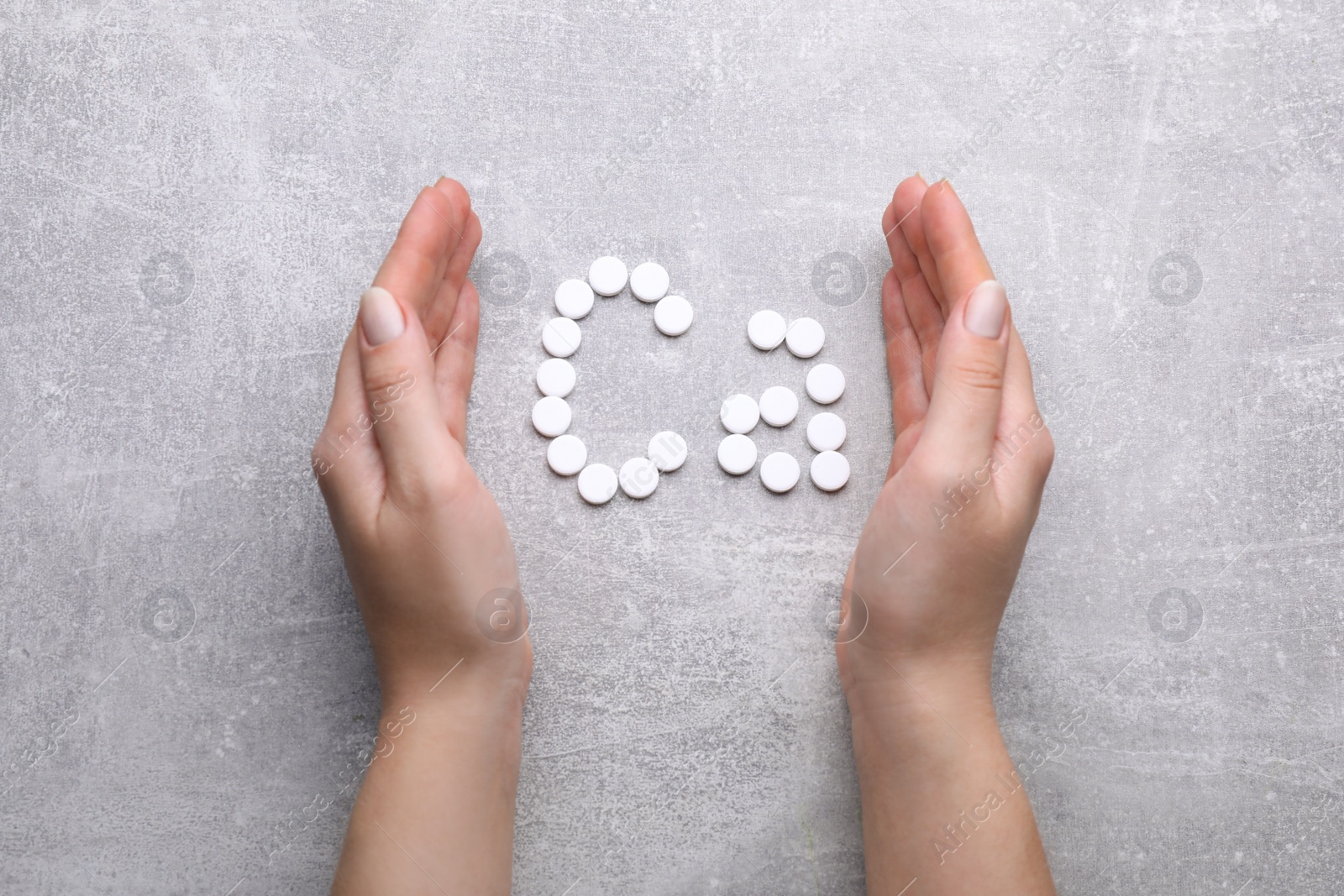 Photo of Woman and symbol Ca (Calcium) of pills on gray background, top view