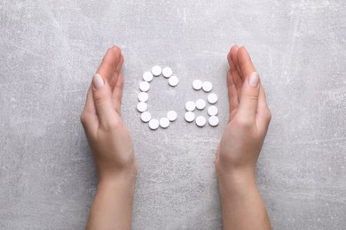 Photo of Woman and symbol Ca (Calcium) of pills on gray background, top view