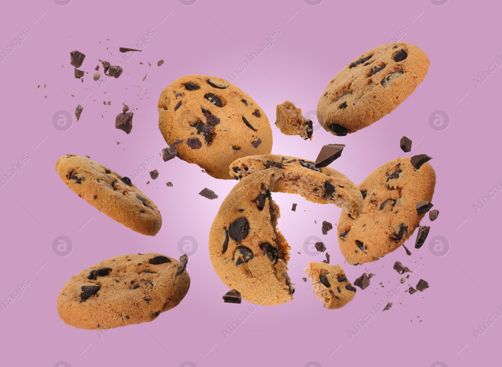 Image of Tasty chocolate chip cookies falling on dusty pink background