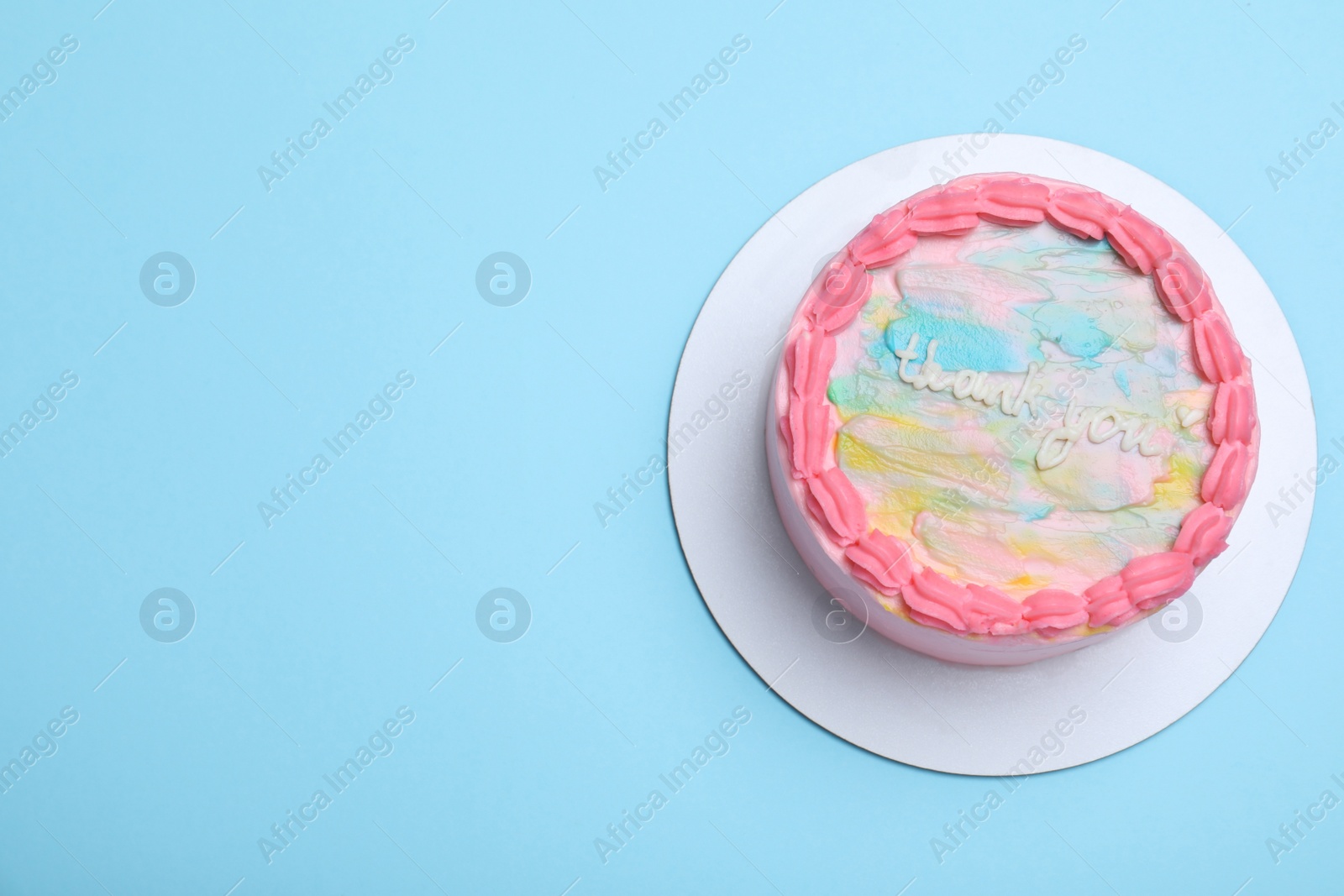 Photo of Cute bento cake with tasty cream on light blue background, top view. Space for text