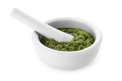 Photo of Mortar of tasty pesto sauce and pestle isolated on white