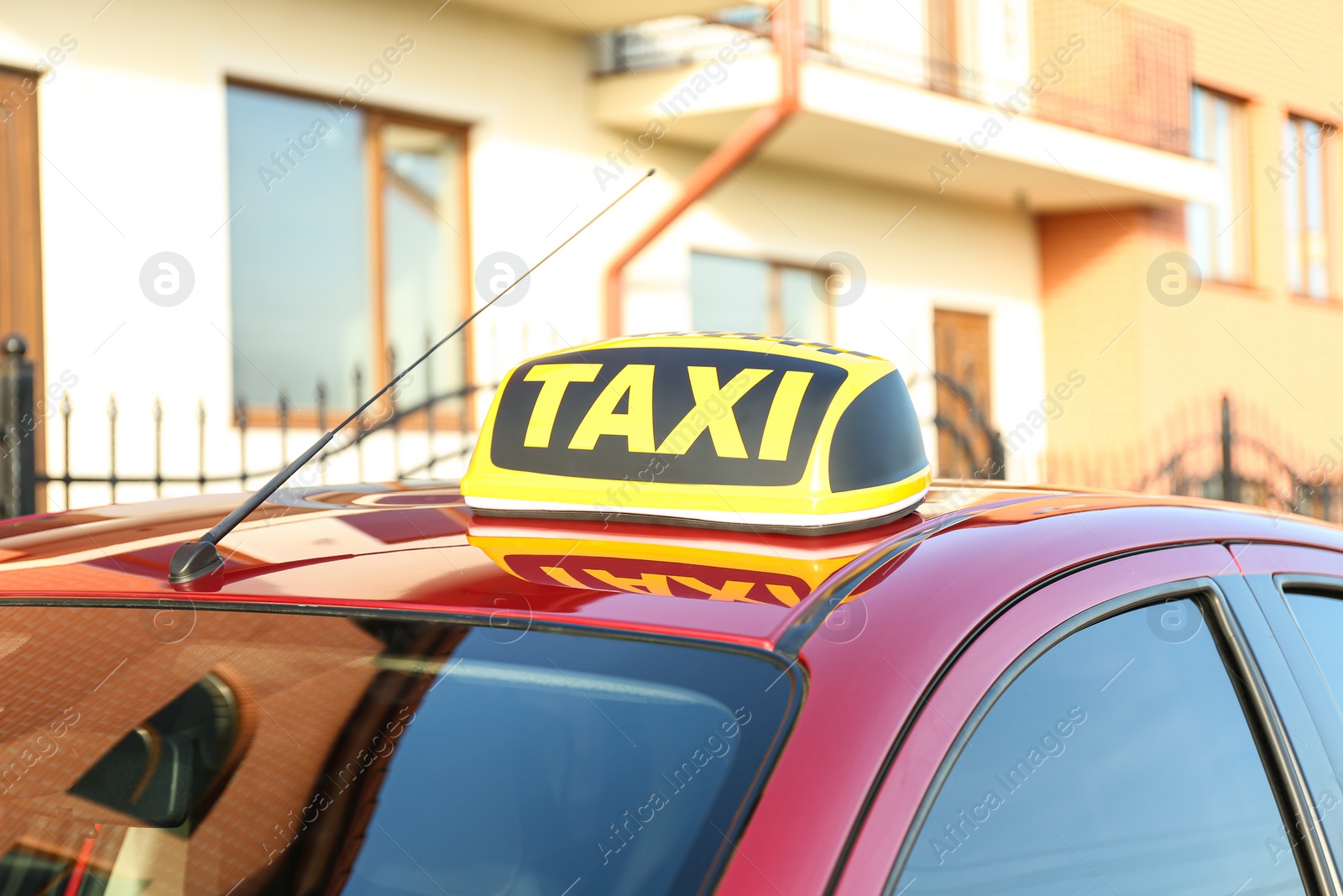 Photo of Roof light with word TAXI on car outdoors