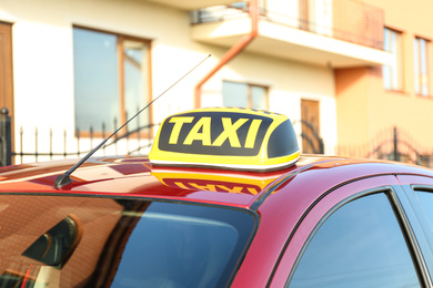 Photo of Roof light with word TAXI on car outdoors