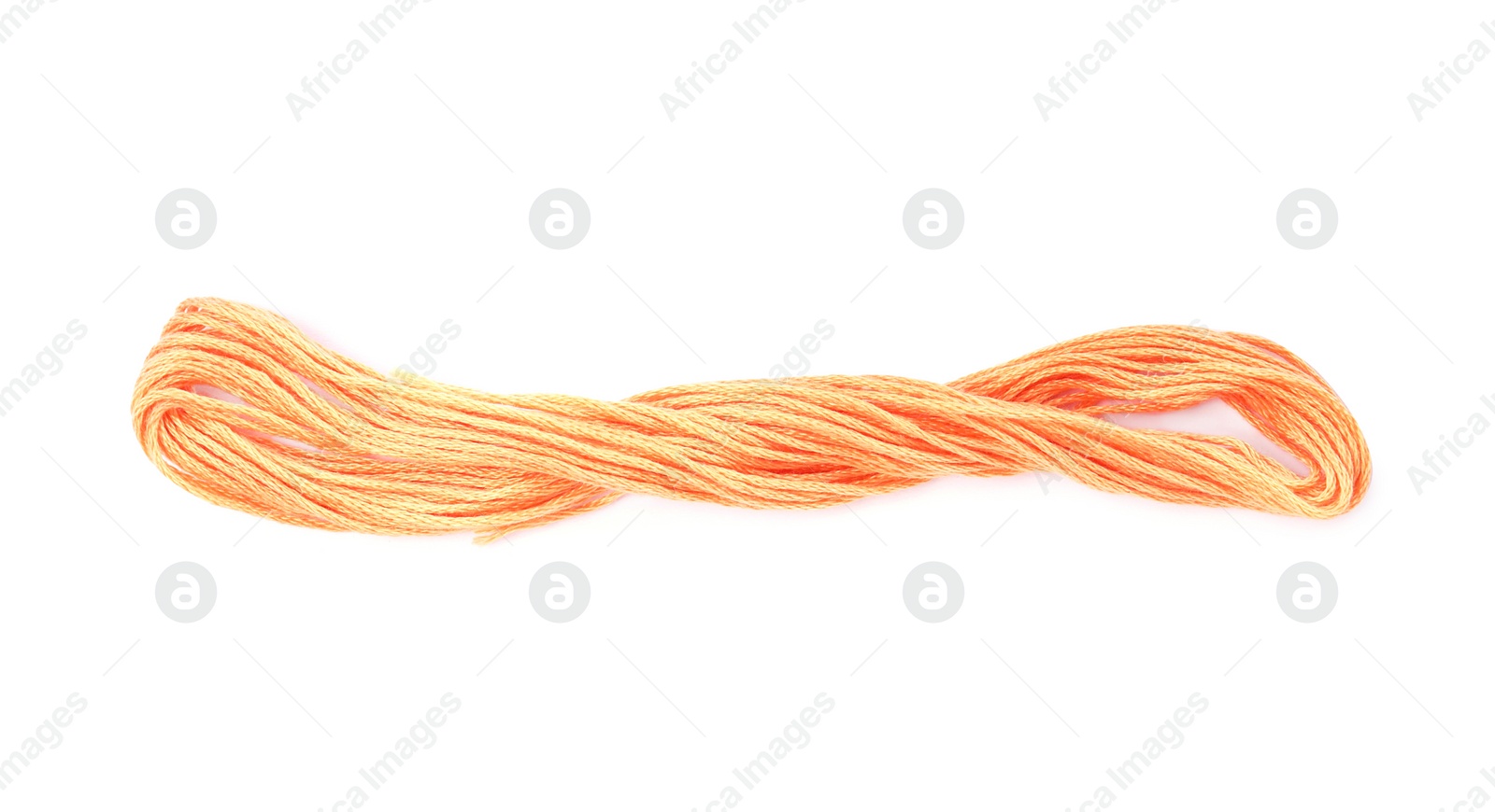 Photo of Pale orange embroidery thread on white background