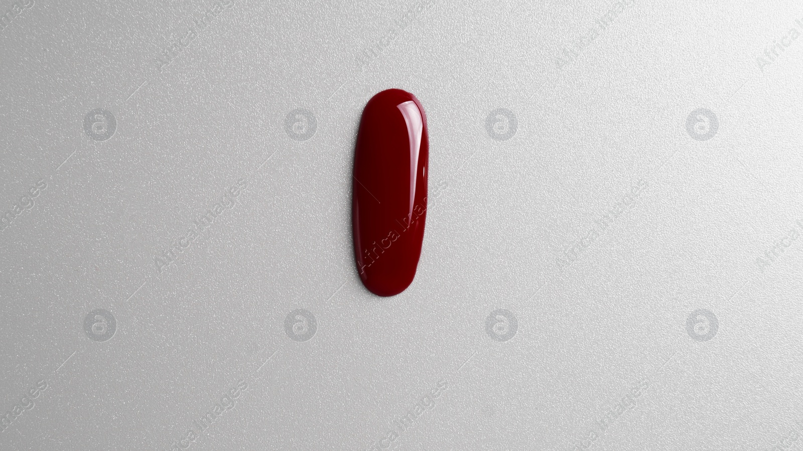 Photo of Drop of blood on grey background, top view