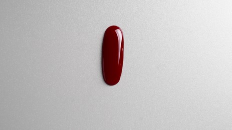 Photo of Drop of blood on grey background, top view