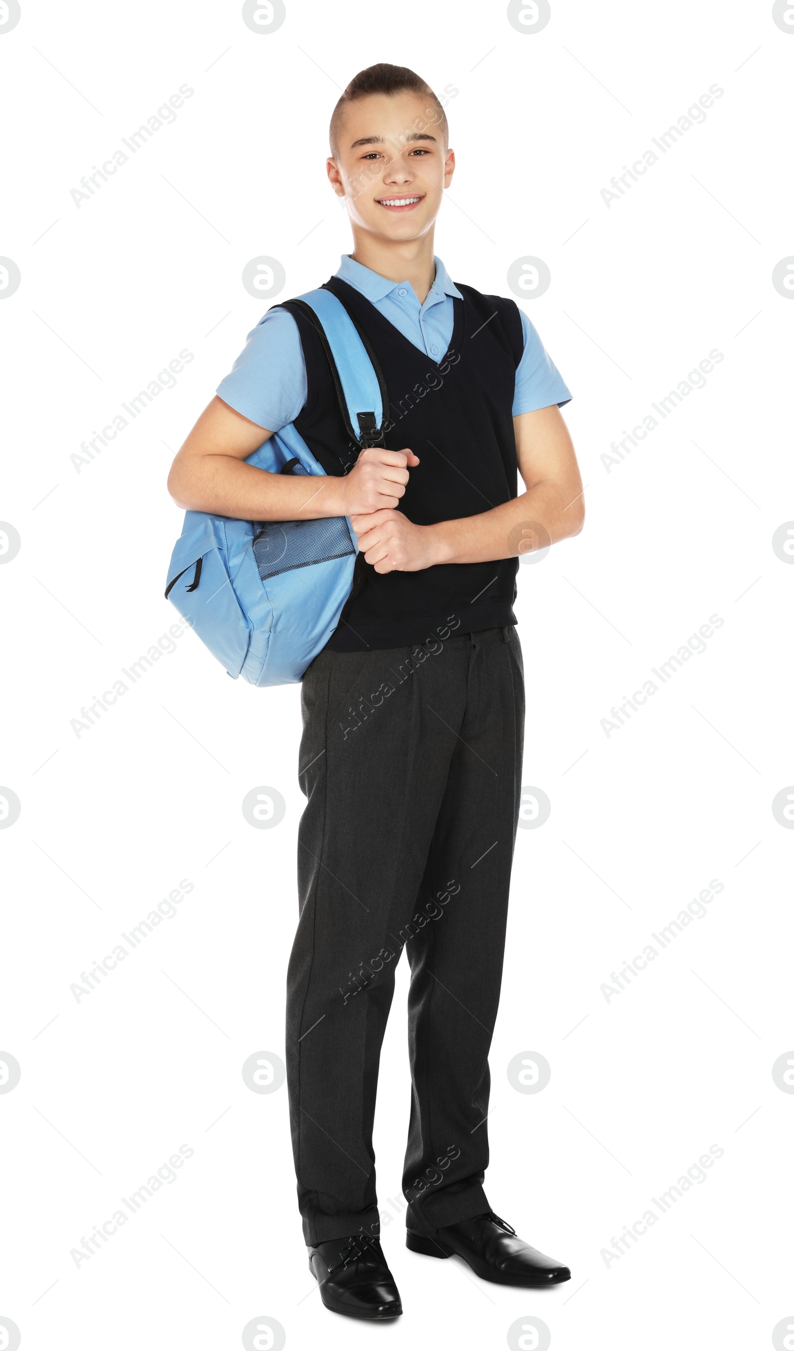 Photo of Full length portrait of teenage boy in school uniform with backpack on white background