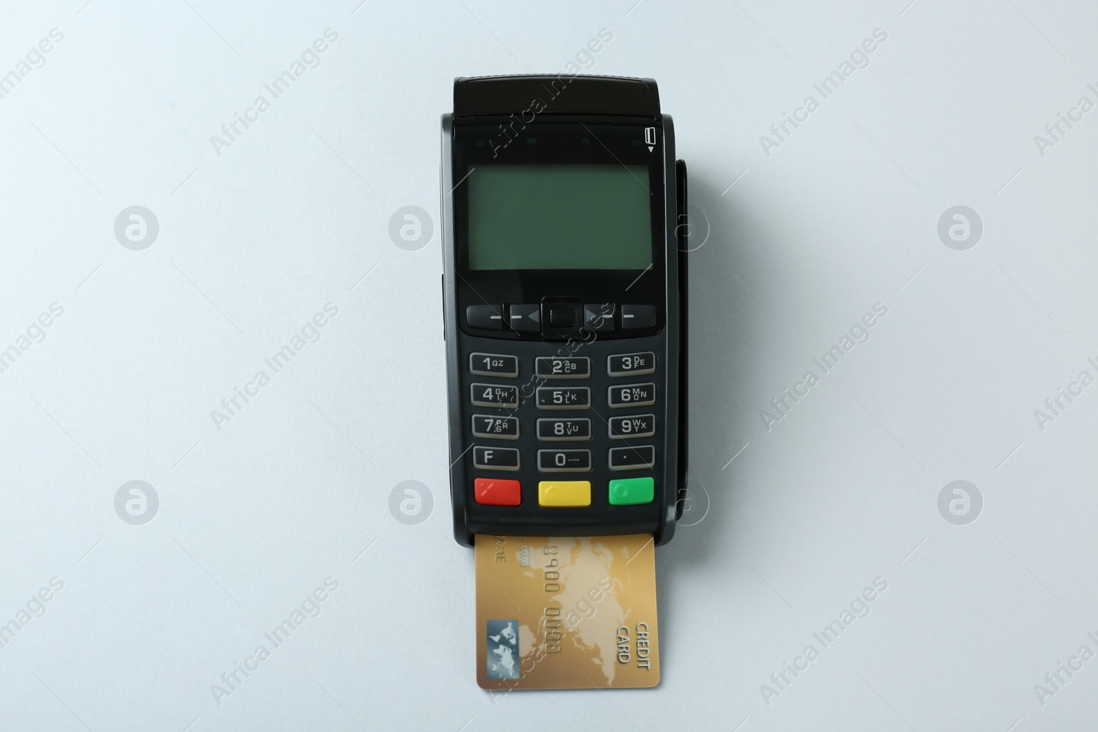 Photo of New modern payment terminal with credit card on light background, top view