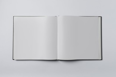 Open book on white background, top view