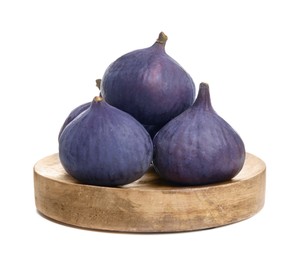 Wooden plate with whole fresh purple figs isolated on white