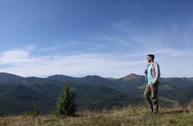 Man enjoying picturesque view of mountain landscape on sunny day