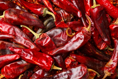 Photo of Dry chili peppers as background, closeup