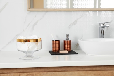 Jar with cotton pads on bathroom countertop