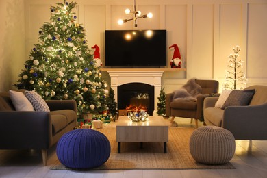 Cozy living room interior with stylish knitted poufs and Christmas tree