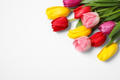 Photo of Many beautiful colorful tulips on white background