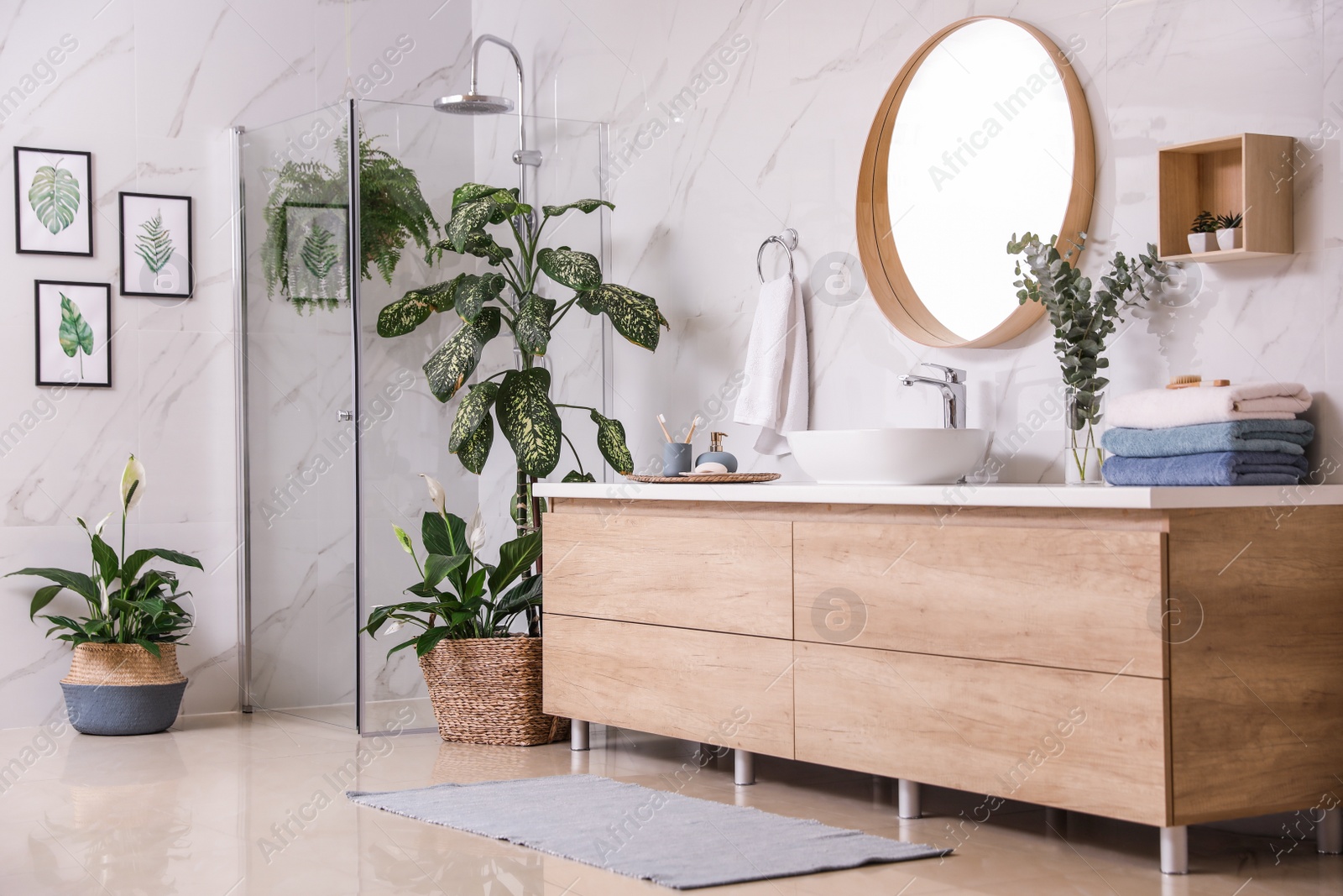 Photo of Green plants in elegant modern bathroom. Interior design