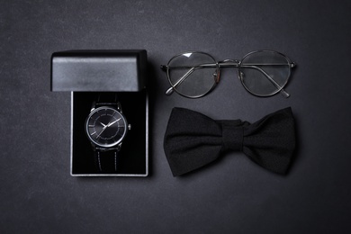 Men set with stylish accessorizes on black background, flat lay