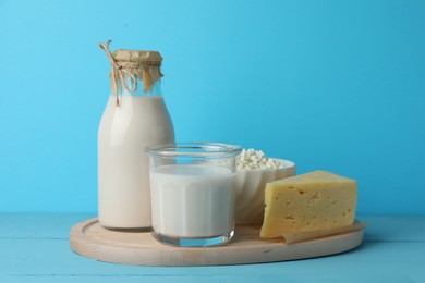 Photo of Lactose free dairy products on light blue wooden table