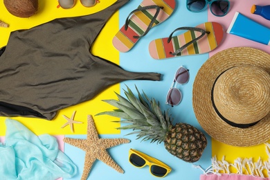 Flat lay composition with beach accessories on colorful background