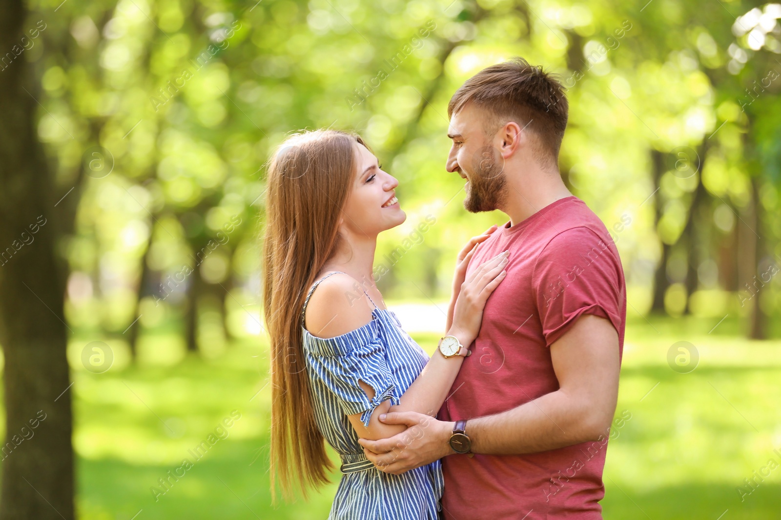 Photo of Happy young couple in green park on sunny spring day