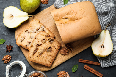 Flat lay composition with pear bread on black slate table. Homemade cake