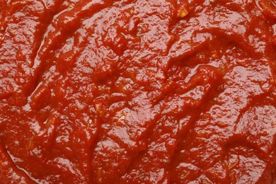 Photo of Homemade tomato sauce as background, top view