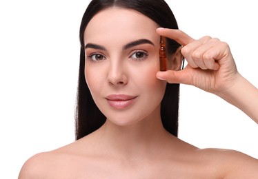 Photo of Beautiful young woman holding skincare ampoule on white background