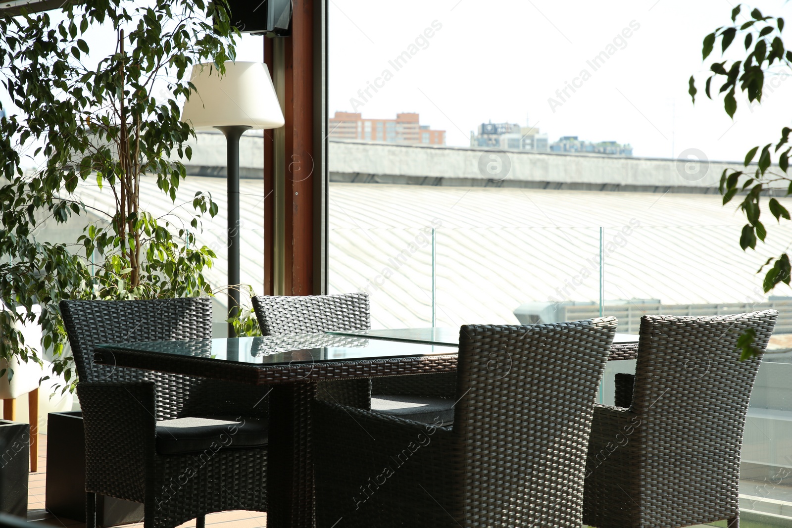 Photo of Observation area cafe. Table, chairs and green plants on terrace