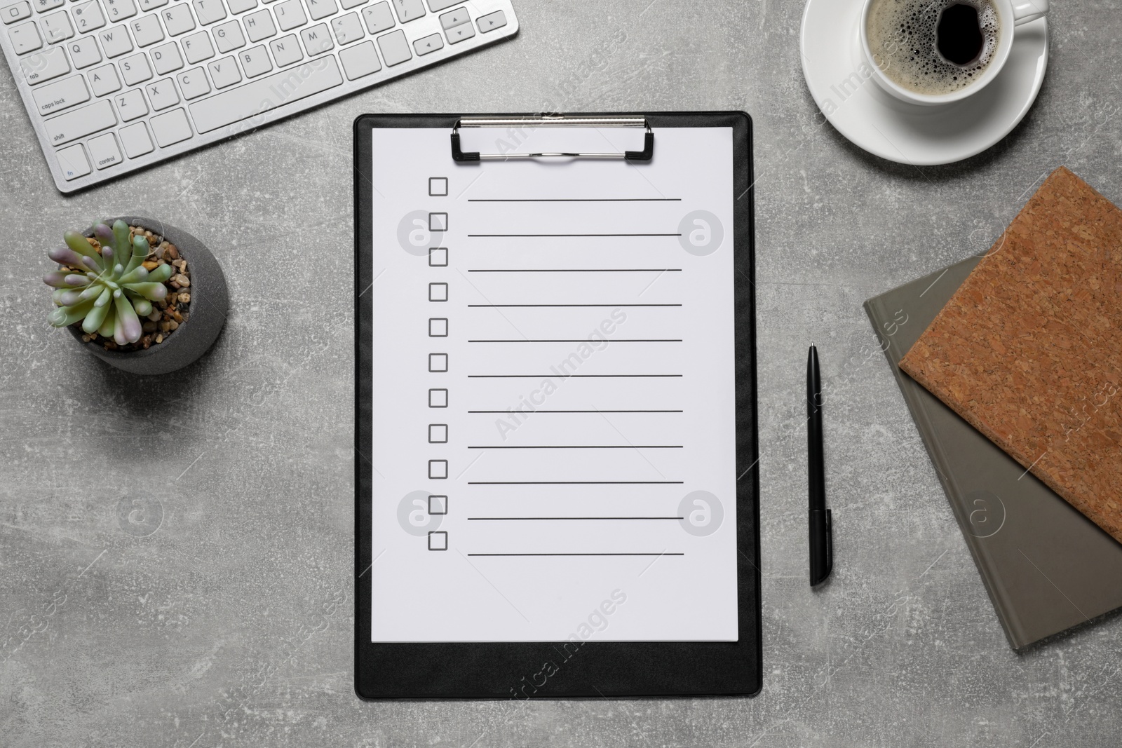 Photo of Clipboard with checkboxes, cup of coffee plant and computer keyboard on grey table, flat lay. Checklist