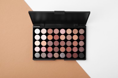 Eye shadow palette on colorful background, top view