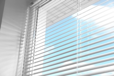 Photo of Closeup view of window with horizontal blinds, low angle view