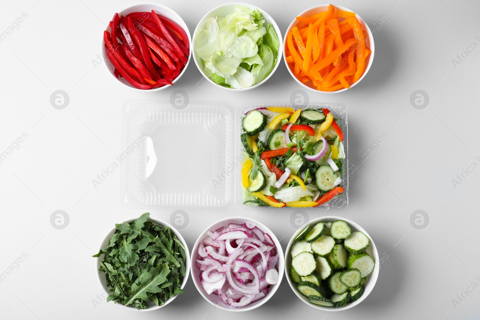 Photo of Fresh salad and ingredients on white background, top view