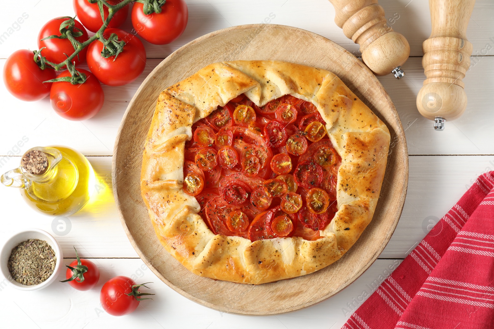 Photo of Flat lay composition with tasty tomato galette (Caprese galette) on white wooden table