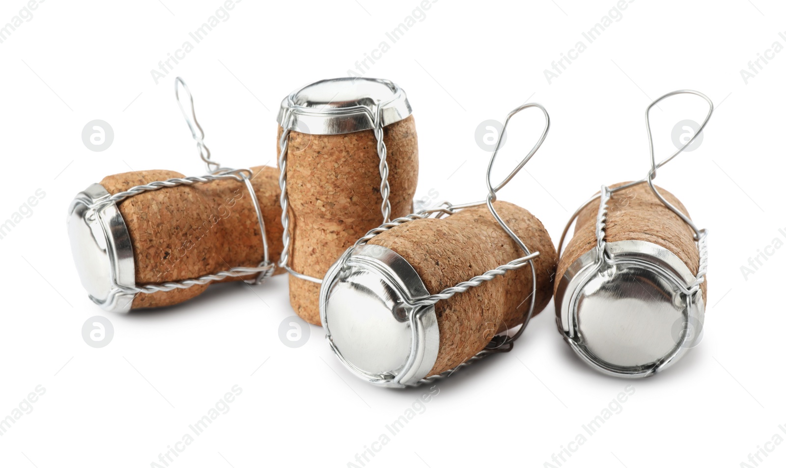 Photo of Sparkling wine corks with muselet caps on white background