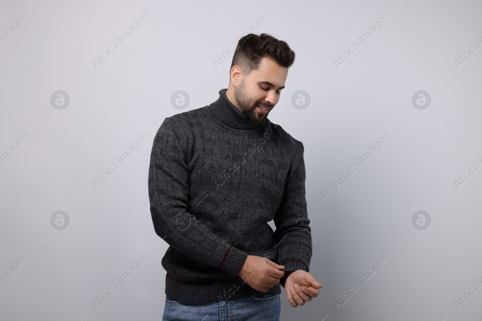 Photo of Happy man in stylish sweater on white background